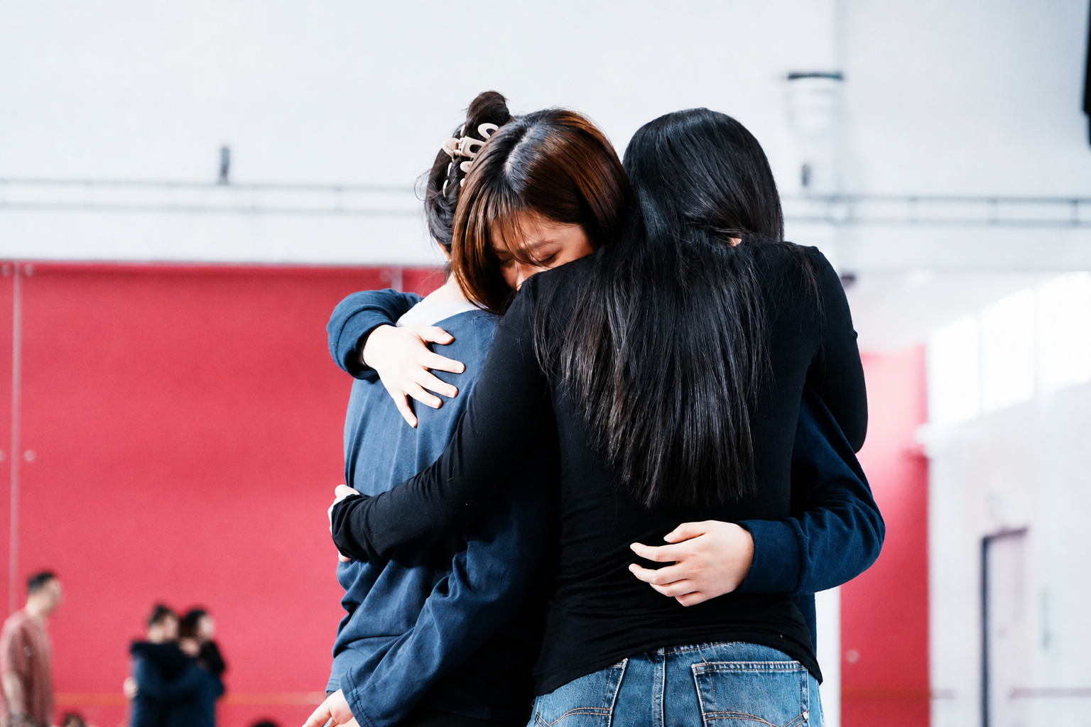 A small group sharing a supportive moment during practice